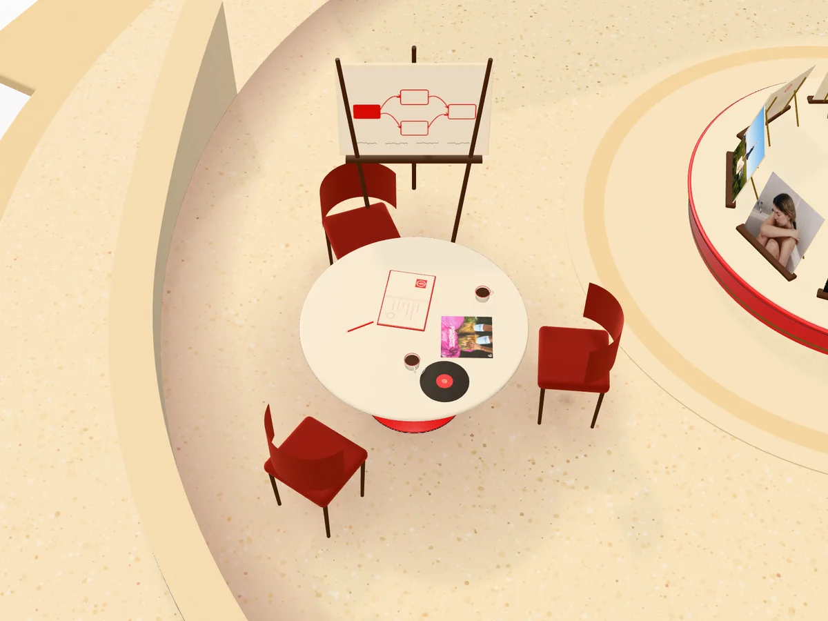 The table: a notebook, two coffees and a record, with a whiteboard behind